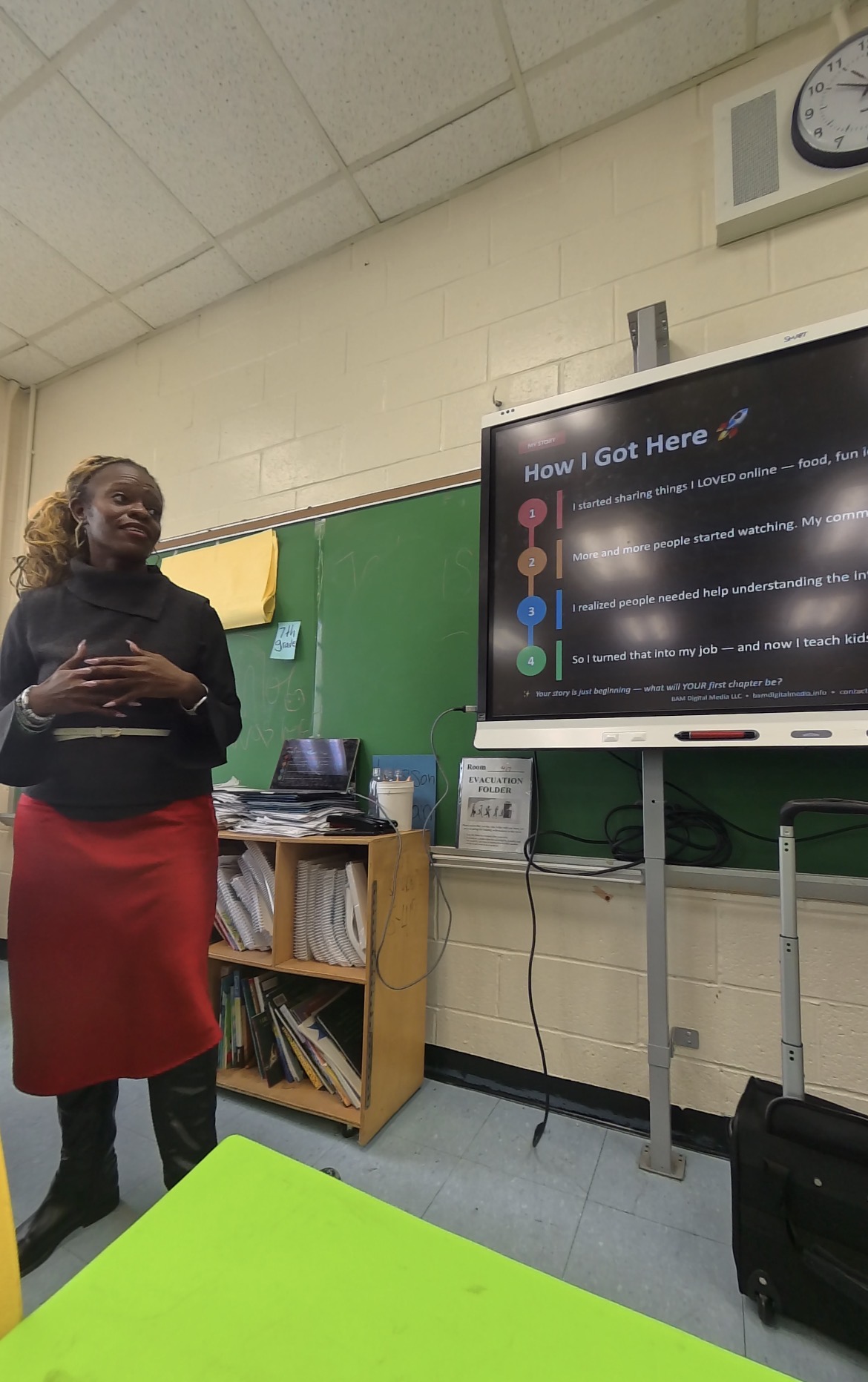 Schnelle presenting to a class in a black turtleneck