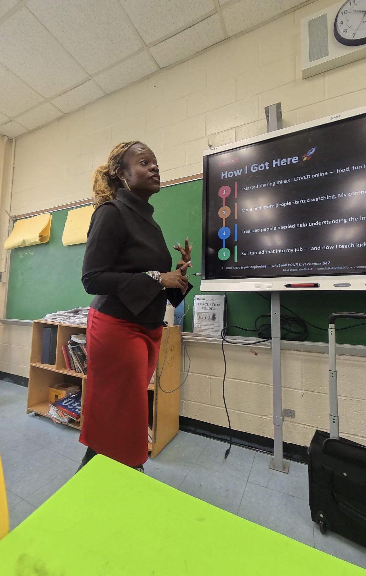 Classroom setting with How I Got Here slide visible