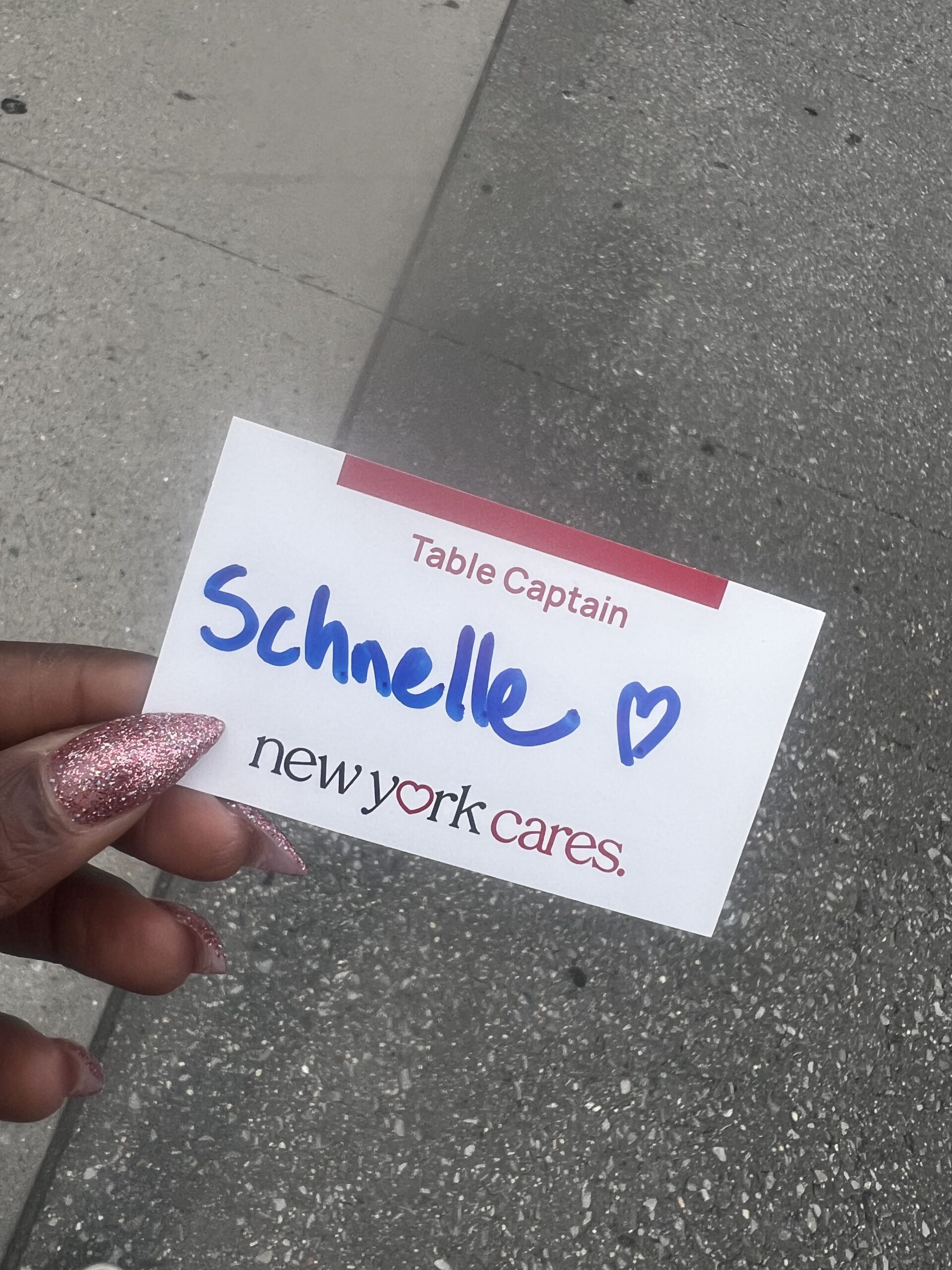 Table Captain name badge reading Schnelle, New York Cares